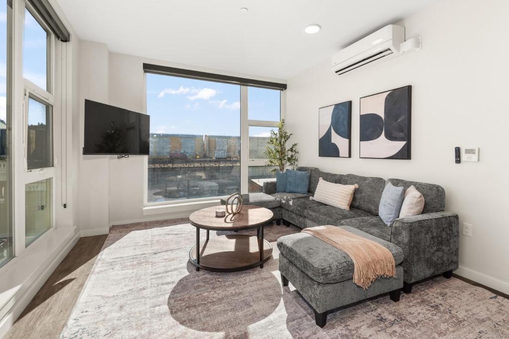 a living room with a couch and a table at 2BR Cozy Apartment in DT in Spokane