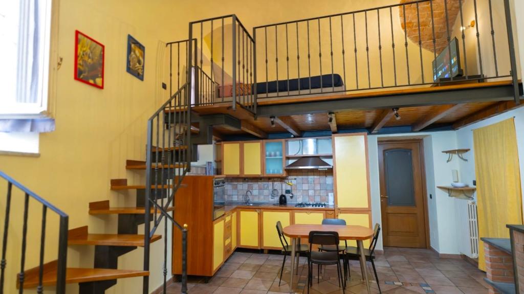 a kitchen with a spiral staircase in a room at Living Adua Centro in Tortona