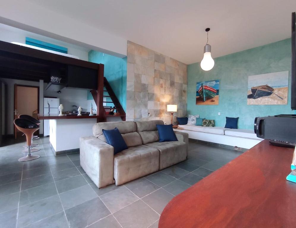 un salon avec un canapé et une cuisine dans l'établissement Modern loft con vista mar, à Búzios