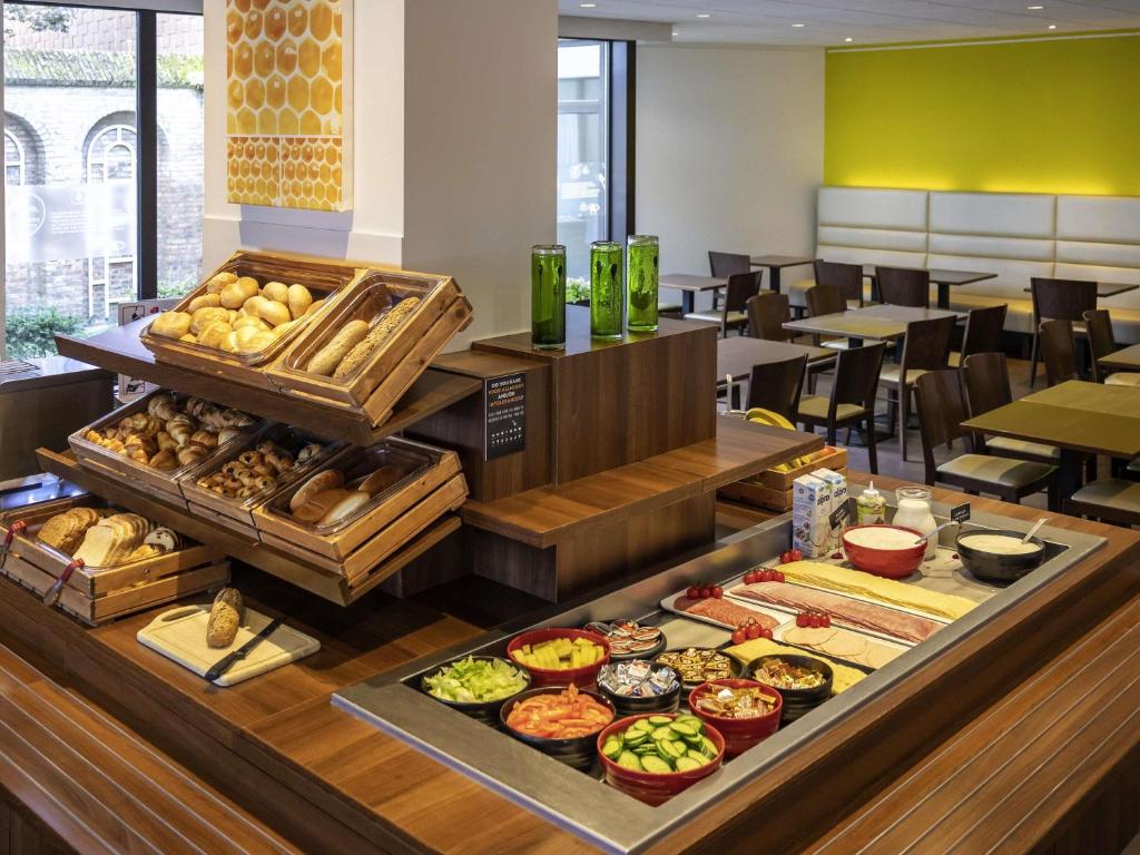 uma fila de bufê com diferentes tipos de comida em um restaurante em ibis Antwerpen Centrum em Antuérpia