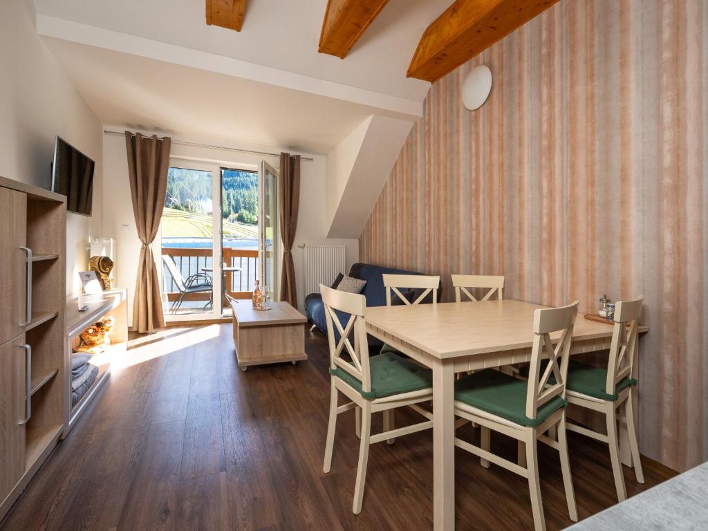 a dining room with a table and chairs at Apartment No.28 Jasná in Belá