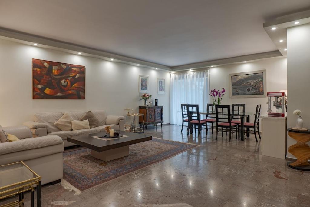 a living room with a couch and a table at Spacious & central 2BR apt in Agia Paraskevi in Athens