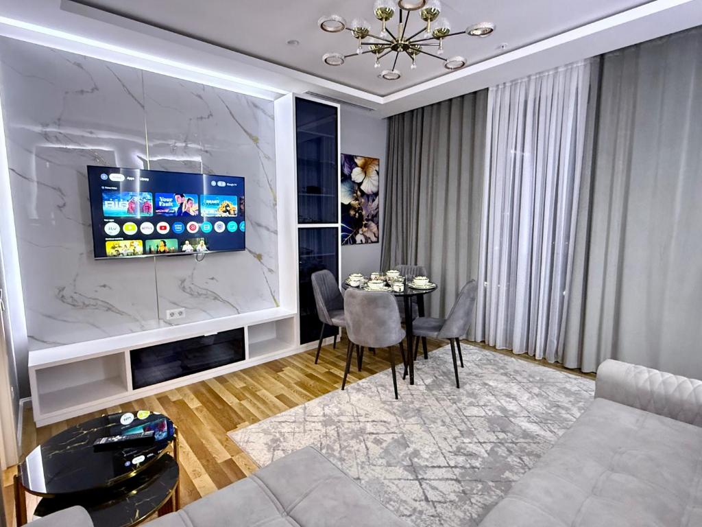a living room with a couch and a table at Nest one, Tashkent City in Tashkent