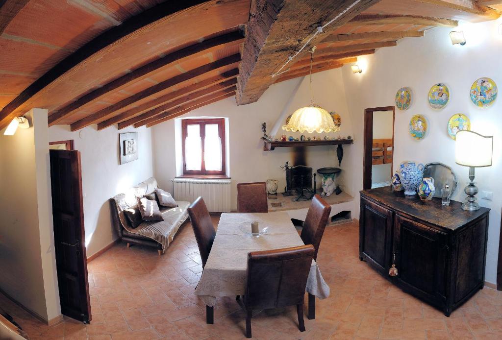 a living room with a table and a couch at In Borgo -Legoli in Peccioli