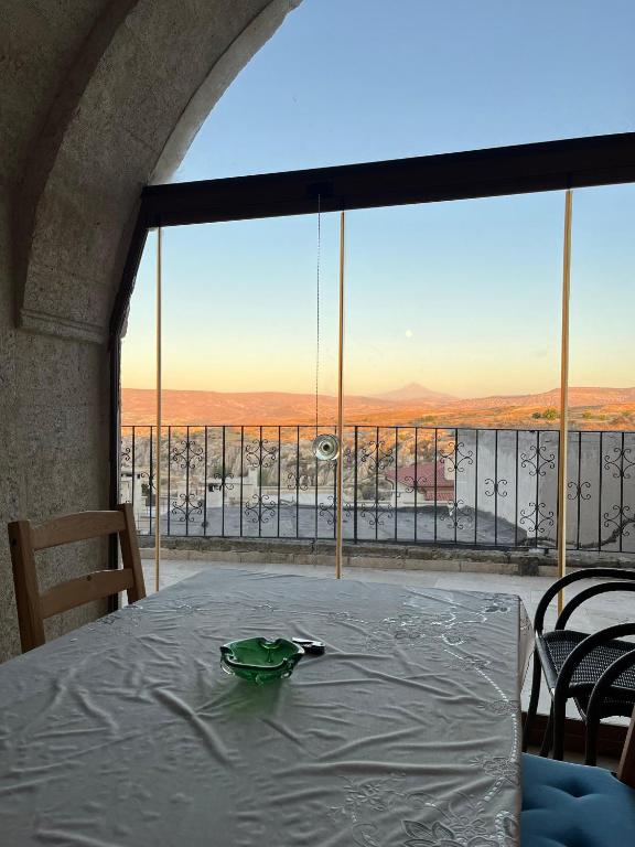 a table in a room with a large window at Cosy cave suit in Urgup