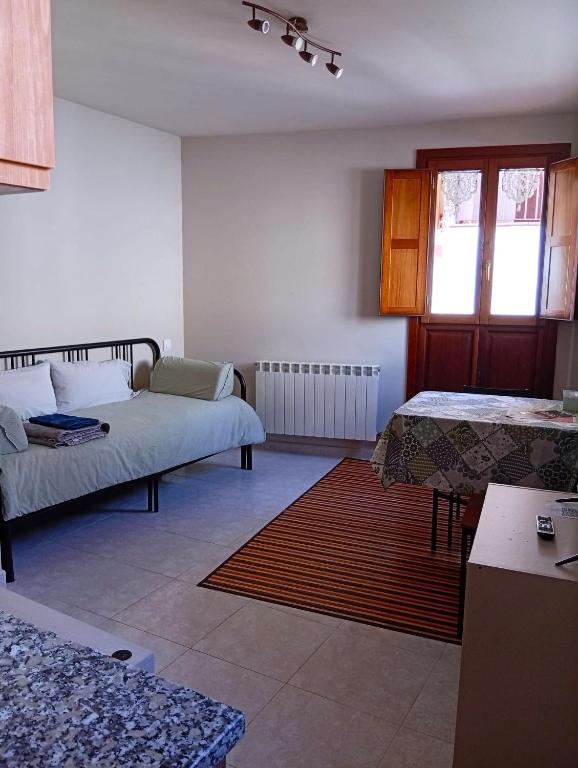 a living room with a bed and a table at Coqueto Estudio 2 in Ezcaray