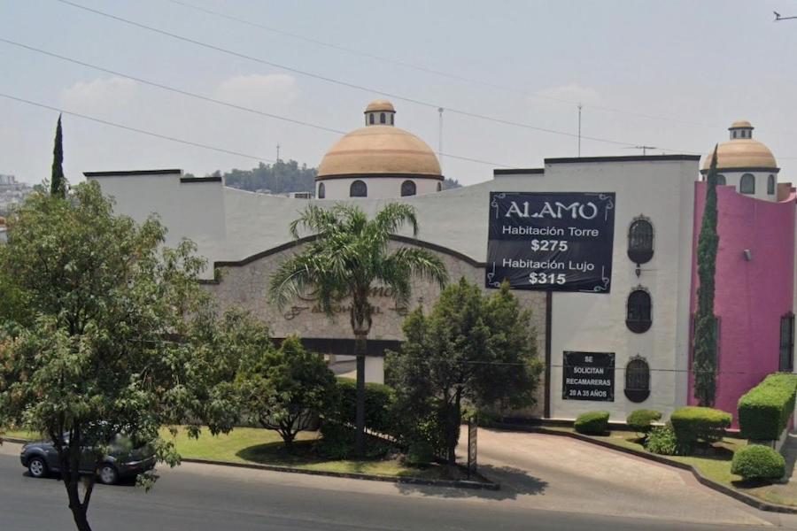 a building with a sign in front of it at motel alamo in Guadalajara