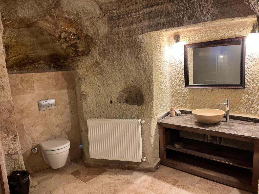 a bathroom with a sink and a toilet at Cosy cave suit in Urgup