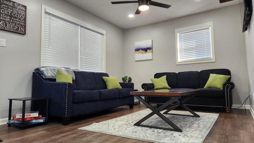 a living room with a blue couch and a table at Little House in Indy sleeps many in Indianapolis