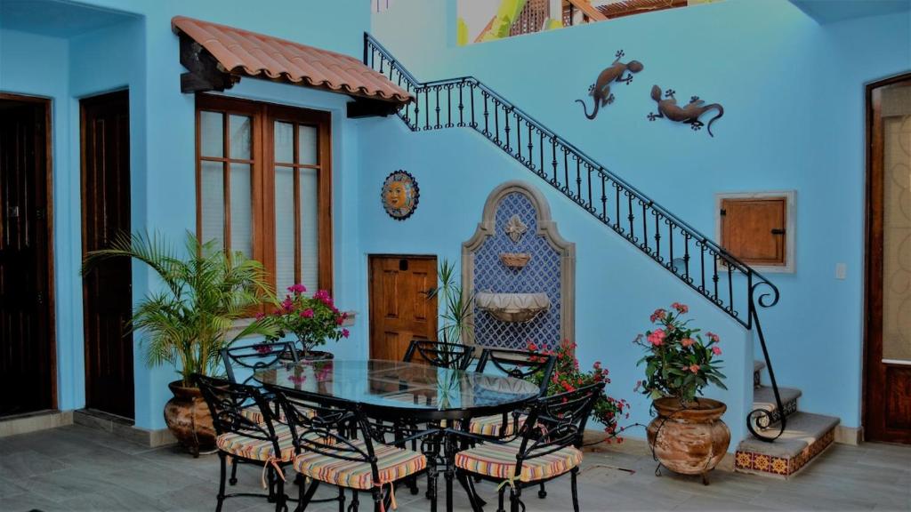 a dining room with a table and a blue wall at Casa Mar de Cortez in Loreto