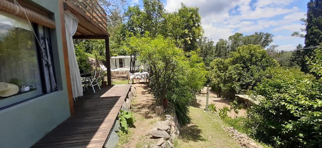 a porch of a house with two cows standing on it at Vista Alago in Villa Ciudad Parque