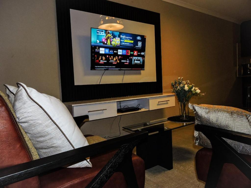 a living room with a flat screen tv and a couch at Poplar place Thornton in Cape Town