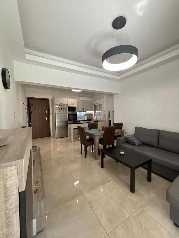 a living room with a couch and a table at Spacious & Fully Equipped 2-Bedroom Apartment in Heraklion in Heraklio