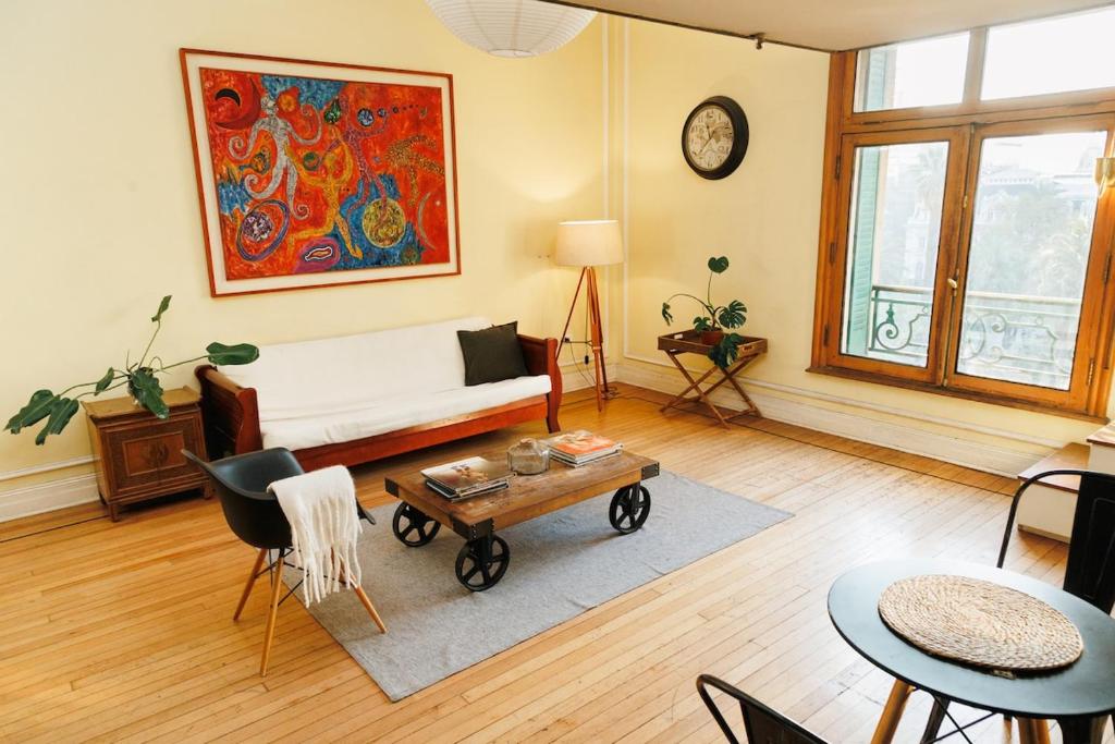a living room with a couch and a table at Historic Loft Overlooking Plaza de Armas in Santiago
