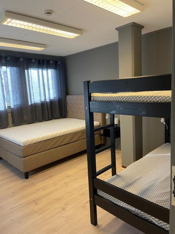 a dorm room with two bunk beds in it at Ankenes Romutleie AS in Narvik