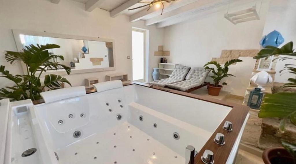 a large white room with a couch and a large window at Vico Sauro Apartament in Veglie
