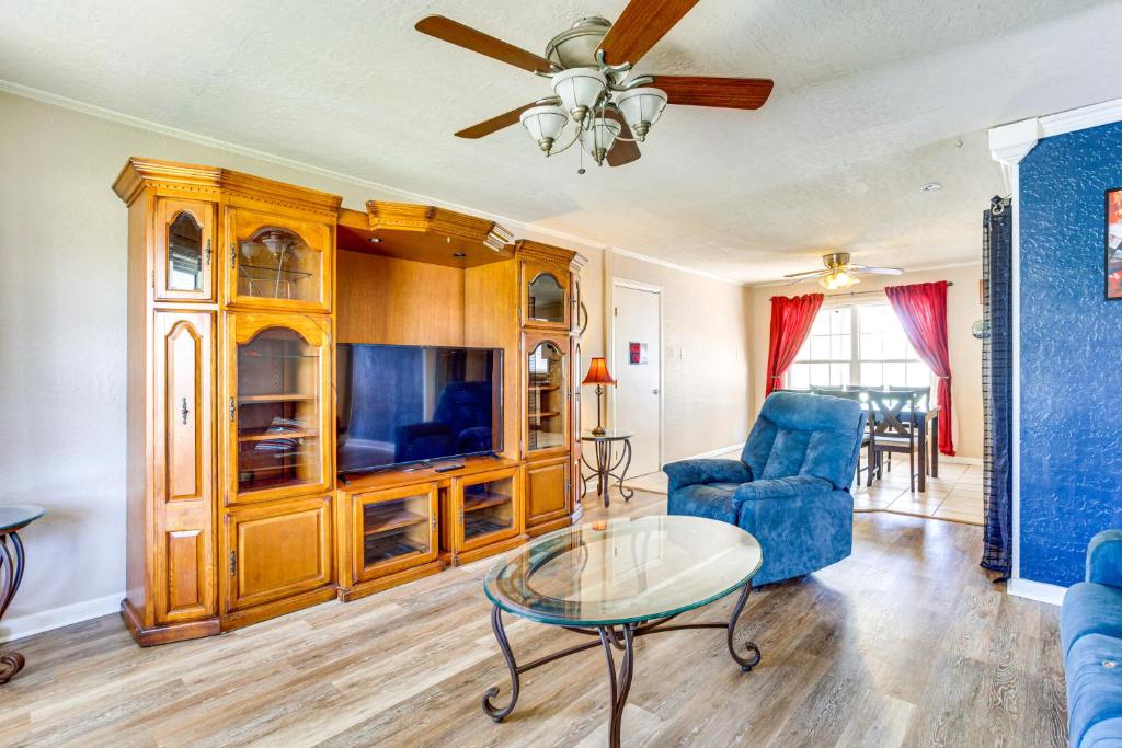 a living room with a blue couch and a table at 2 Mi to Fort Sill Quiet Family Retreat with Yard in Lawton