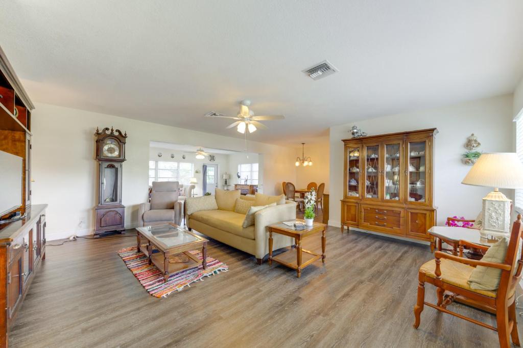 a living room with a couch and a table at Walk to The Cove! Central Deerfield Beach Home in The Cove