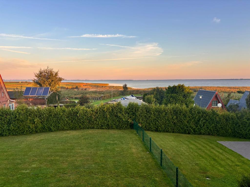 a view of the ocean from the backyard of a house at Kranichhaus Boddenblick in Saal