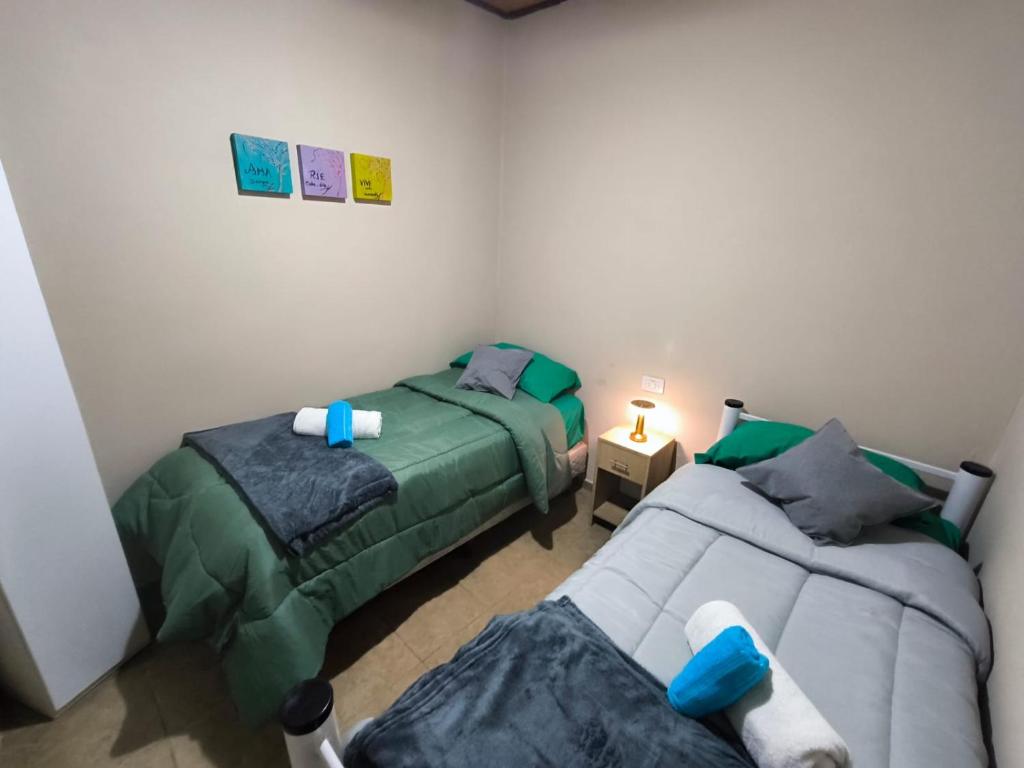 a bedroom with two beds and a couch at Parvis Magna HOSTAL in Barraquero