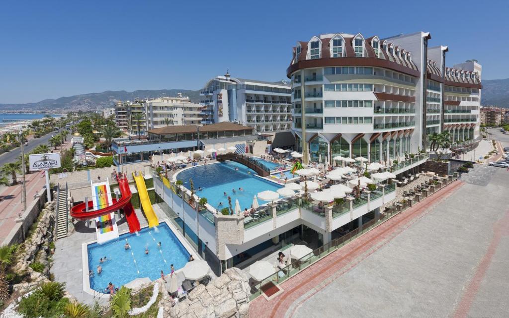 a resort with a pool and a water slide at Asia Beach Resort & Spa Hotel in Alanya