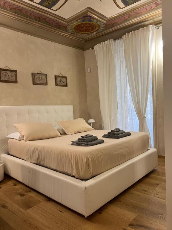 a large white bed in a bedroom with a ceiling at FresCo b&b in Sarnico
