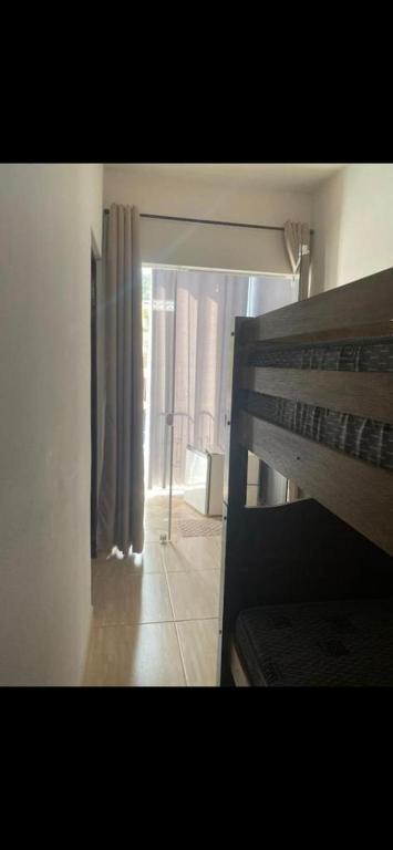 a room with a window and a bed in a room at Espaço Clarabella in Serra Negra