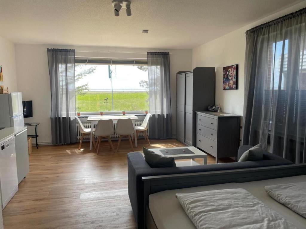 a living room with a couch and a dining room table at Ferienwohnung-Neuwerk in Baltrum