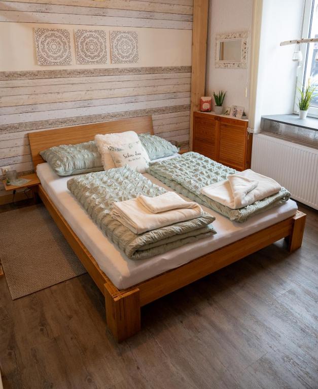 a bedroom with a large bed with pillows on it at Traumfänger in Heltersberg