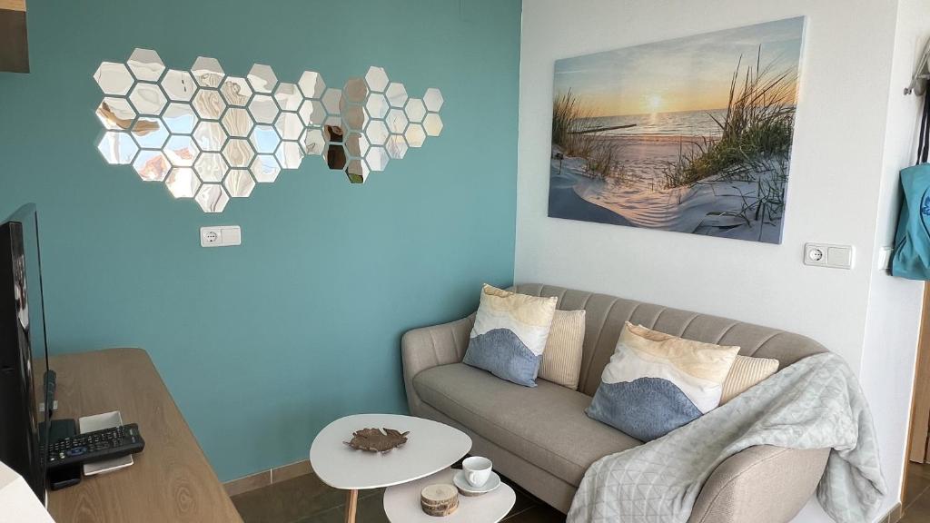 una sala de estar con sofá y un corazón en la pared en Wake up to the Oceanfront Panoramic 180º Beachview Torrox-Costa Ruselo R408 ONLY ADULTS, en Torrox Costa