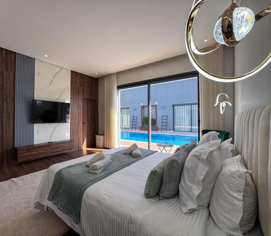 a bedroom with a large bed with a view of a pool at Villa Ramona in Marrakech
