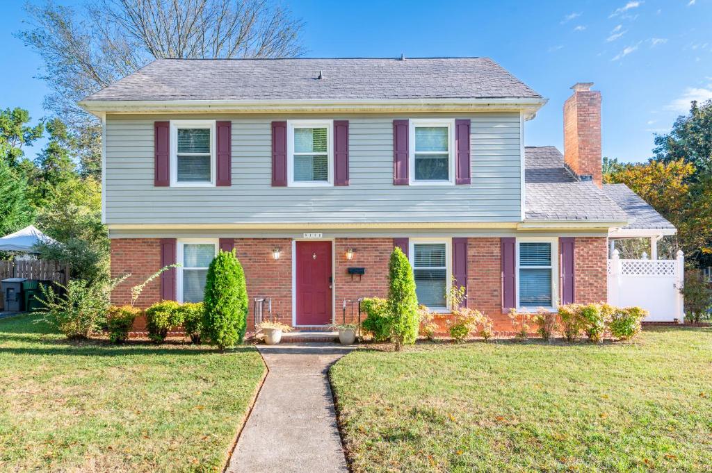 a house with a red door and a yard at Space of Peace in Charlotte