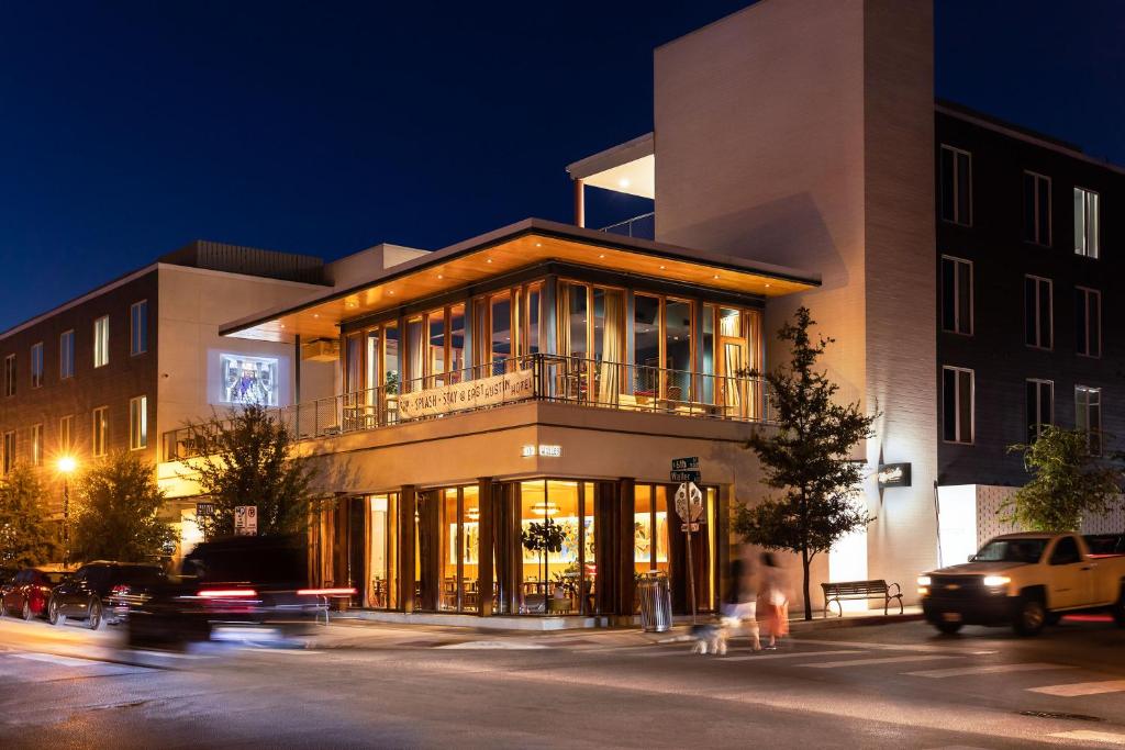 a building on the corner of a street at night at The Cabins at East Austin Hotel in Austin