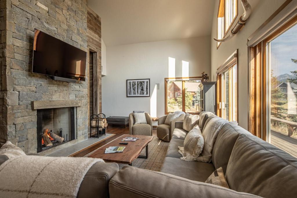 a living room with a couch and a fireplace at Southfork Retreat in Big Sky