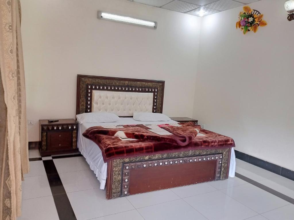 a bedroom with a bed in a room at Bhurban Apartments Bhurban Murree Pakistan in Murree