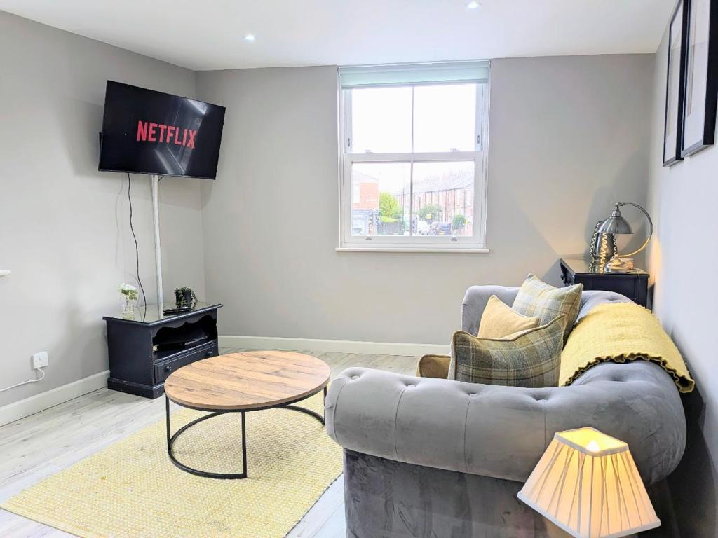 a living room with a couch and a table at Old Yarn Apartment - Close to city walls in York