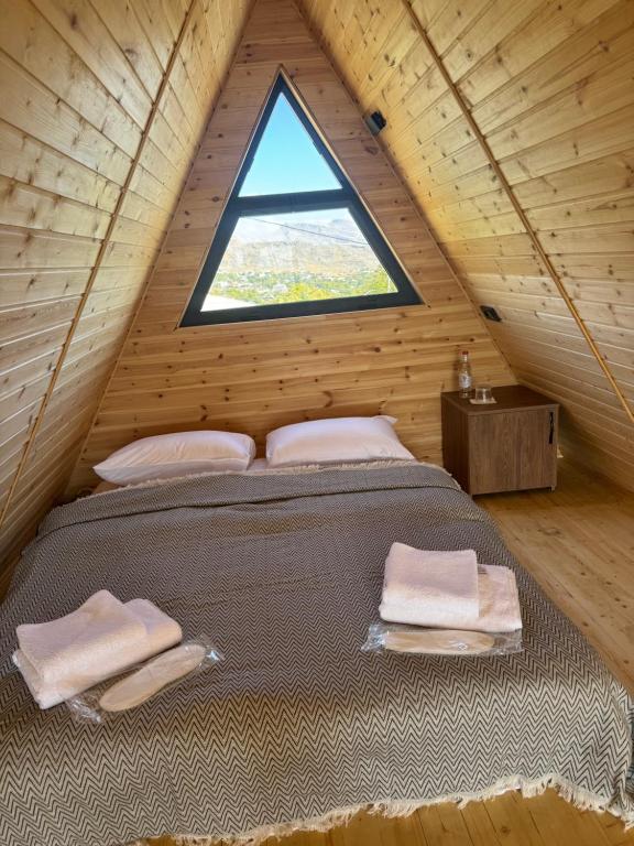 a bedroom in a tiny house with a window at Canyon Resort in Yeghegnadzor