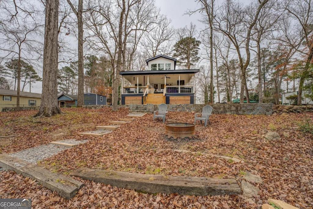 a house sitting on top of a pile of leaves at Lakefront Getaway on Jackson Lake - 3BR-2BA-Hottub in Covington