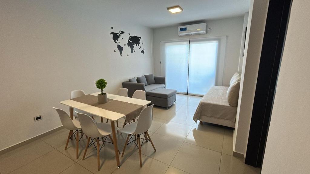 a living room with a table and chairs and a couch at Departamento Bitcoins House Rivadavia in Corrientes