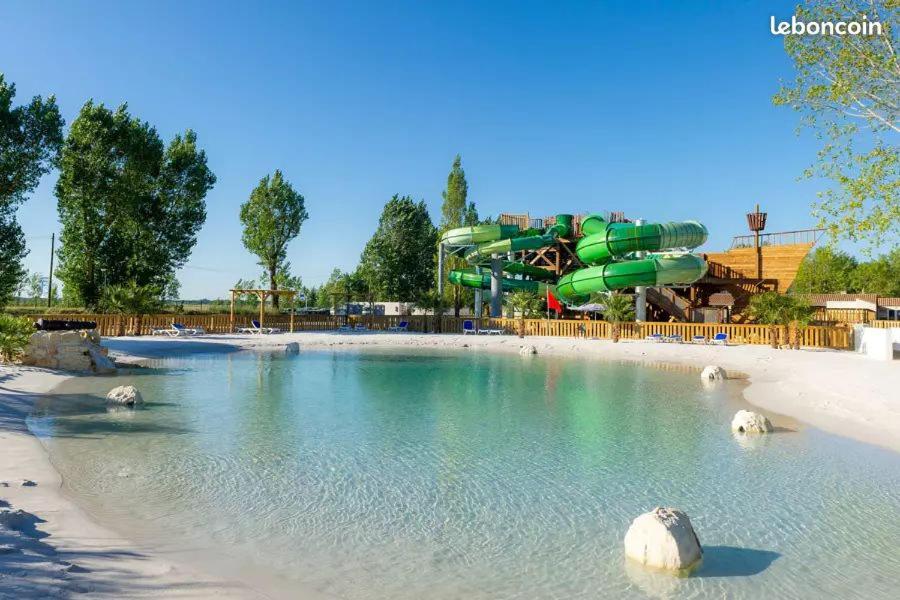 a water park with a water slide in the background at Mobil home 6 personne in La Tranche-sur-Mer