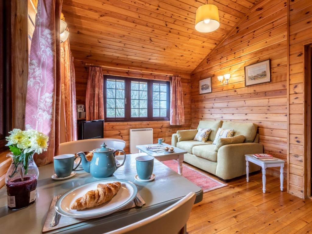 a living room with a table with a plate of food at 1 Bed in Clovelly 00354 in Clovelly