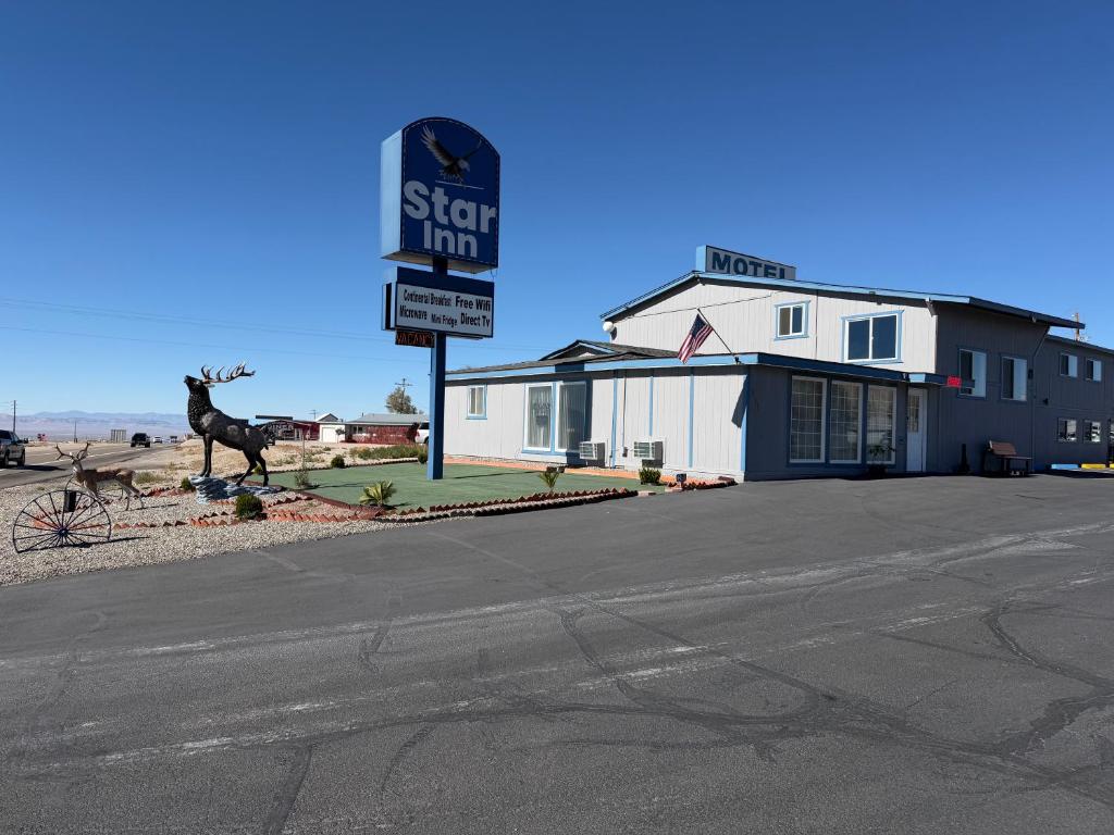a sign for a store with a camel in front of it at Star Inn in Tonopah