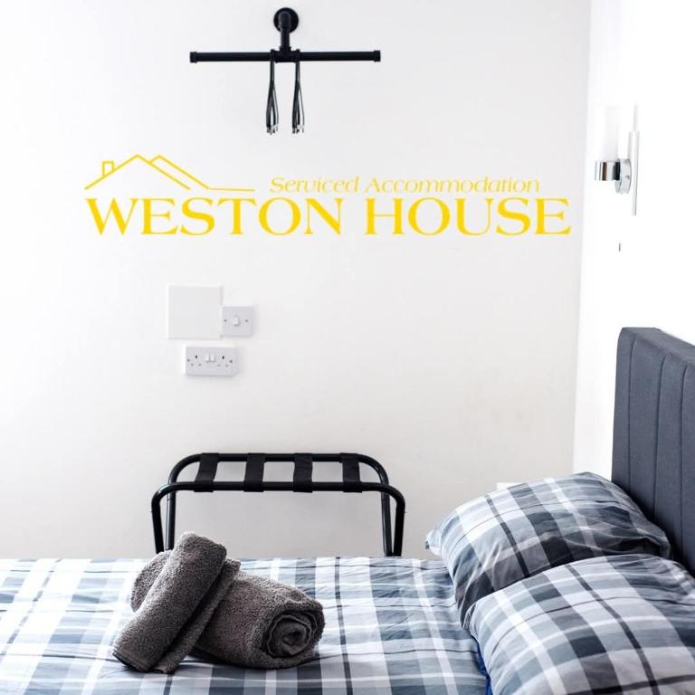 a bedroom with a weston house sign on the wall at Weston House Keith in Keith