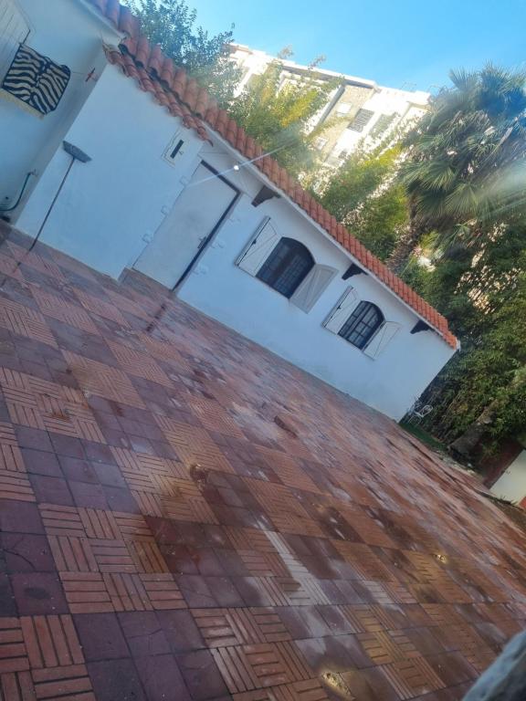 a white house with a red tile roof at We'llcome home in Temara