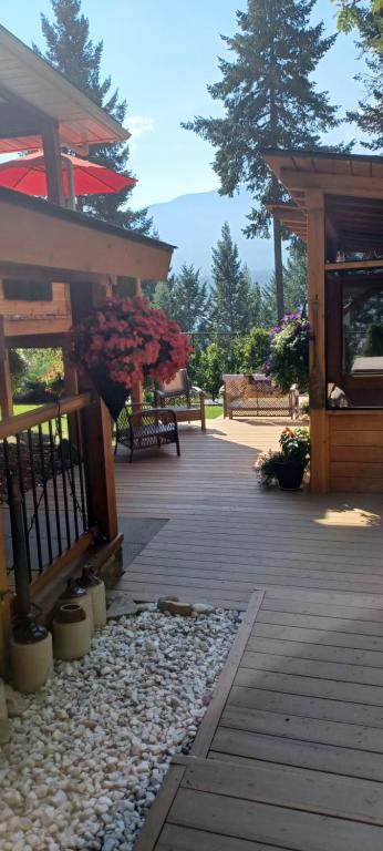 a porch of a building with a fence and flowers at Deer Ridge B&B in Golden