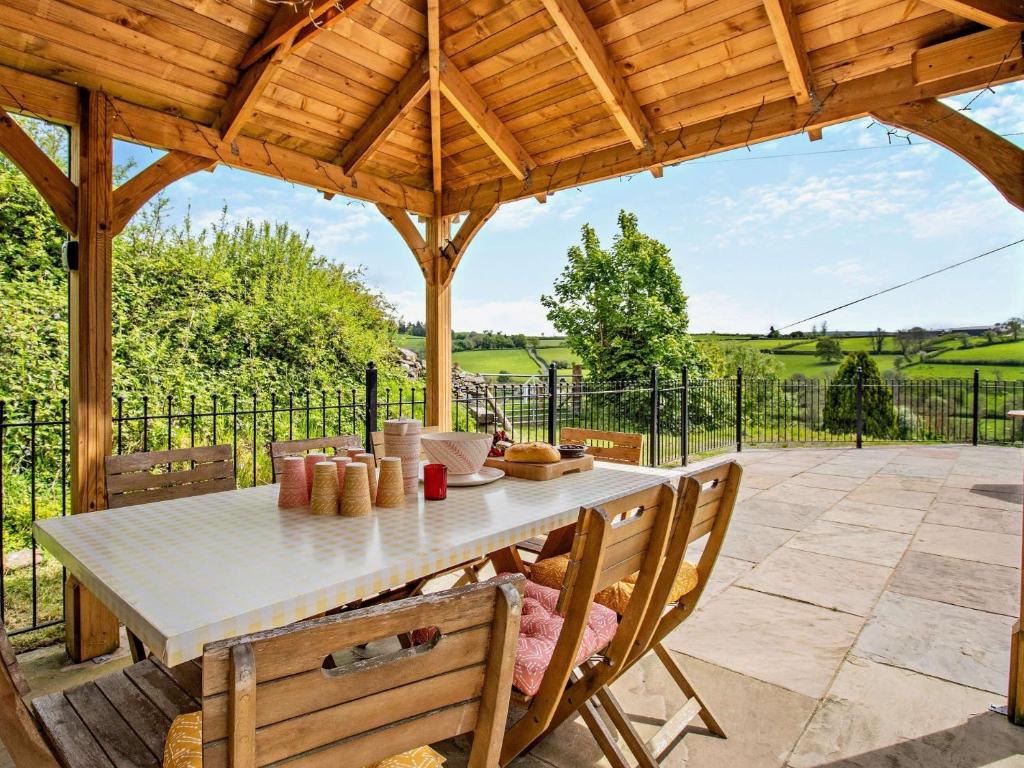 a wooden pavilion with a table and chairs on a patio at 4 Bed in Cray 82529 in Cray