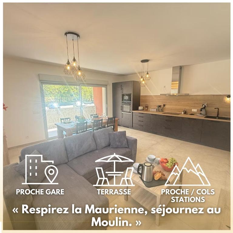 a living room with a couch and a kitchen at Le Moulin Balcon Proche Centre Calme in Saint-Jean-de-Maurienne