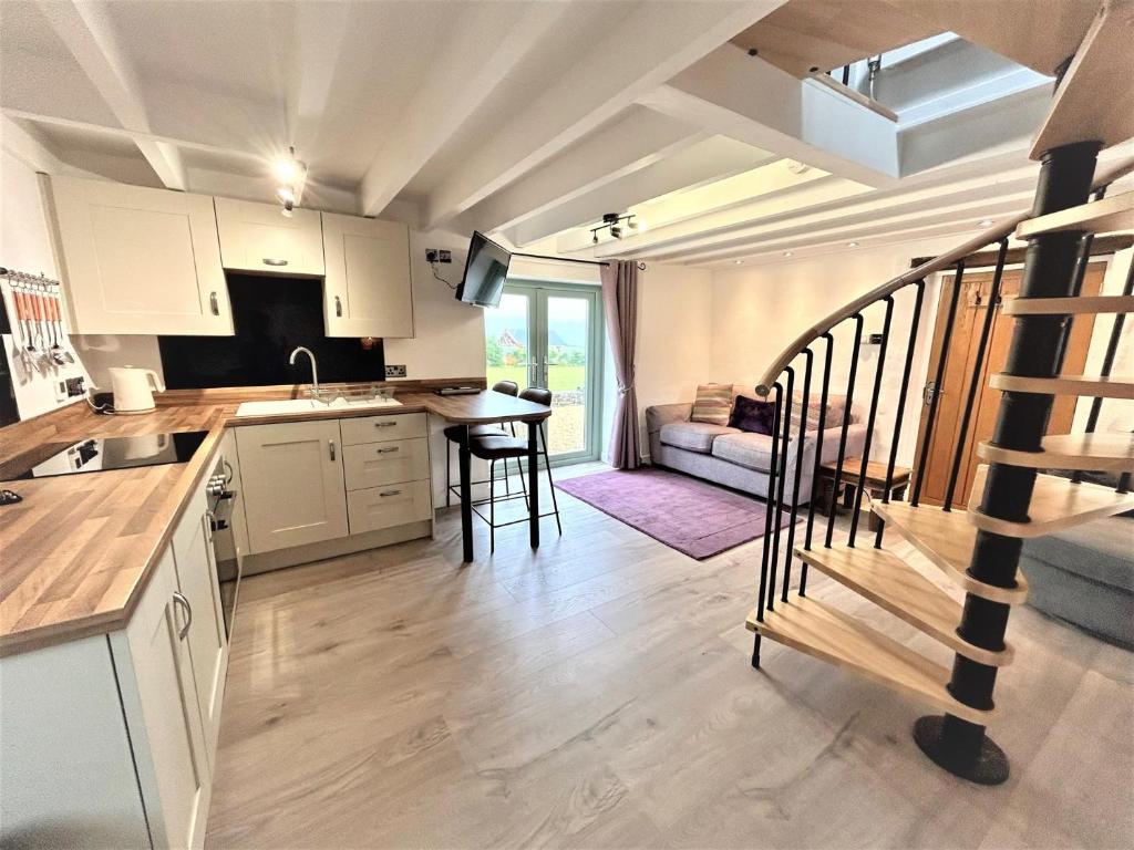 a kitchen with a staircase leading to a living room at 1 Bed in Narberth 72863 in Whitland