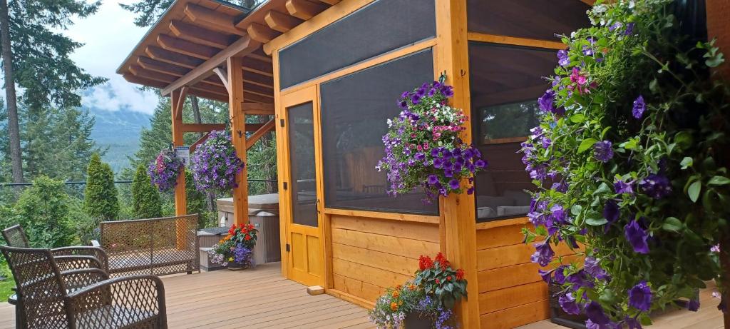a gazebo with purple flowers on a deck at Deer Ridge B&B in Golden