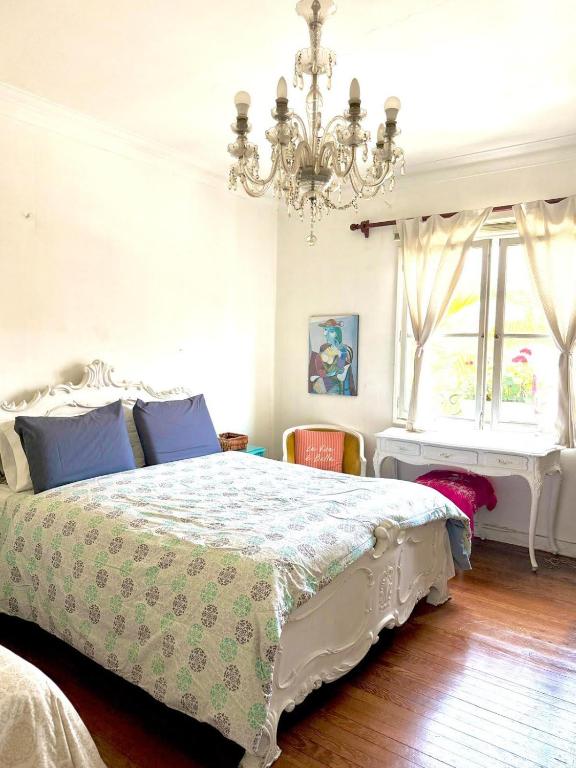 a bedroom with a bed and a chandelier at Miraflores Moonlight B&B in Lima
